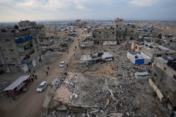 A tent camp for displaced Palestinians is set up amid destroyed buildings in the Khan Younis refugee camp, southern Gaza Strip, Saturday, Jan. 4, 2025. (AP Photo/Abdel Kareem Hana)