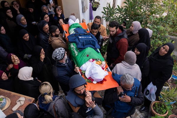 Relatives mourn as the body of Palestinian Shatha al-Sabbagh, a 22-year-old journalism student, is carried out of her family home during her funeral in the Jenin refugee camp in the Israeli-occupied West Bank, Sunday, Dec. 29, 2024. (AP Photo/Majdi Mohammed)