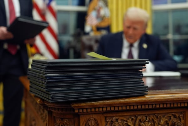 President Donald Trump signs executive orders in the Oval Office of the White House, Monday, Jan. 20, 2025, in Washington. (AP Photo/Evan Vucci)