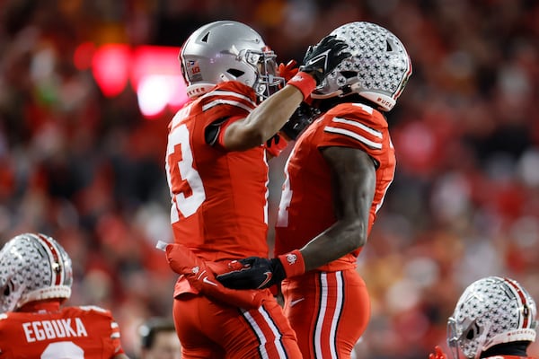 Ohio State receiver Jeremiah Smith, right, celebrates his touchdown against Tennessee with teammate Bryson Rodgers during the first half in the first round of the College Football Playoff, Saturday, Dec. 21, 2024, in Columbus, Ohio. (AP Photo/Jay LaPrete)