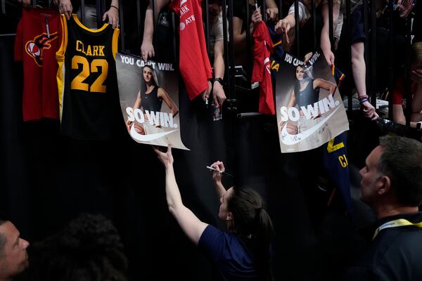 Indiana Fever guard Caitlin Clark, center, gives autographs before an exhibition women's basketball game against Brazil, Sunday, May 4, 2025, in Iowa City, Iowa. (AP Photo/Charlie Neibergall)