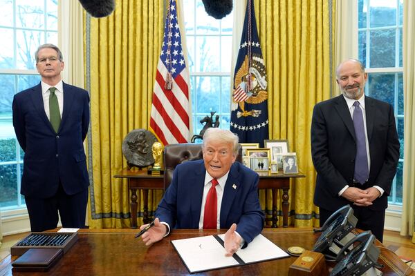 President Donald Trump speaks as Treasury Secretary Scott Bessent, left, and Commerce Secretary Howard Lutnick listen as Trump prepares to sign an executive order in the Oval Office of the White House, Monday, Feb. 3, 2025, in Washington. (AP Photo/Evan Vucci)