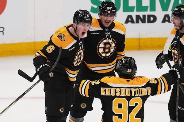 Boston Bruins defenseman Mason Lohrei (6) celebrates after his goal against the Florida Panthers during the third period of an NHL hockey game, Tuesday, March 11, 2025, in Boston. (AP Photo/Charles Krupa)