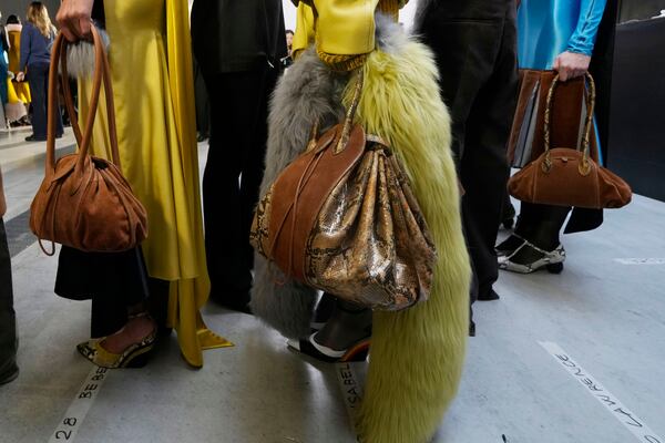 Models get ready in the backstage during the Marni Fall/Winter 2025-2026 Womenswear fashion show, during the Fashion Week, in Milan, Italy, Wednesday, Feb. 26, 2025. (AP Photo/Luca Bruno)