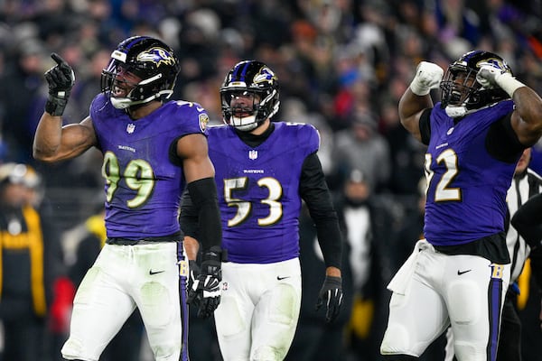 Baltimore Ravens linebacker Odafe Oweh (99) celebrates a sack with teammates linebacker Kyle Van Noy (53) and defensive tackle Nnamdi Madubuike (92) during the second half of an NFL wild-card playoff football game against the Pittsburgh Steelers, Saturday, Jan. 11, 2025, in Baltimore. (AP Photo/Nick Wass)