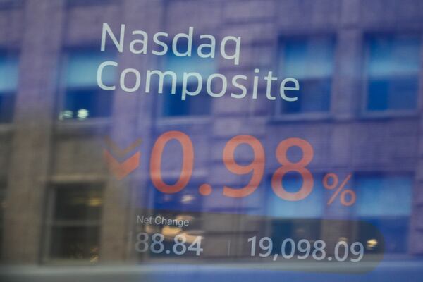 Times Square is reflected in the windows of the Nasdaq MarketSite in New York, Tuesday, Feb. 25, 2025. (AP Photo/Seth Wenig)