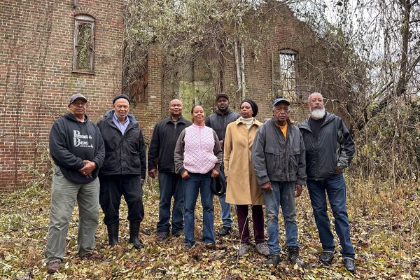 Descendants of Oak Hill sharecroppers stand outside the ruins of the property's once-grand plantation house near Danville, Va., Dec. 10, 2024. (AP Photo/Ben Finley)