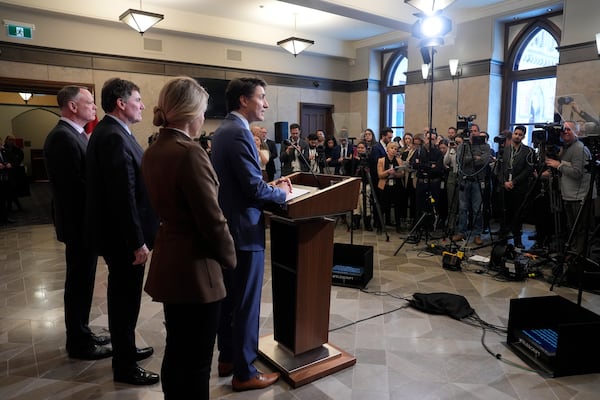 Prime Minister Justin Trudeau holds a news conference on imposed U.S. tariffs as Foreign Affairs Minister Melanie Joly, Finance Minister Dominic LeBlanc and Public Safety Minister David McGuinty look on in Ottawa on Tuesday, March 4, 2025.(Adrian Wyld /The Canadian Press via AP)