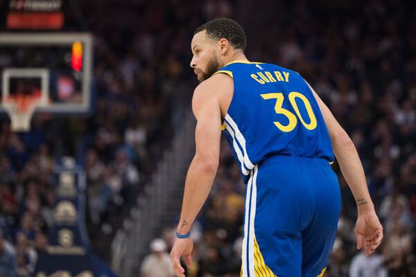 Golden State Warriors guard Stephen Curry looks on during the first half of an NBA basketball game against the Portland Trail Blazers in San Francisco, Monday, March 10, 2025. (AP Photo/Nic Coury)