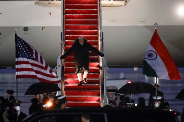 India's Prime Minister Narendra Modi walks down the stairs from his plane upon his arrival at Joint Base Andrews, Md., Wednesday, Feb. 12, 2025. (AP Photo/Luis M. Alvarez)