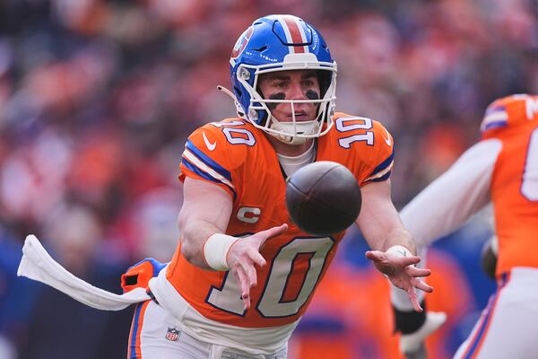 FILE - Denver Broncos quarterback Bo Nix (10) pitches the ball off during the first half of an NFL football game Sunday, Jan. 5, 2025, in Denver. (AP Photo/David Zalubowski, File)