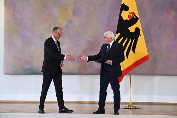 German President Frank-Walter Steinmeier, right, presents Federal Chancellor Friedrich Merz with his certificate of appointment at Bellevue Palace in Berlin, following his election by the German Bundestag, on Tuesday May 6, 2025. (Bernd von Jutrczenka/dpa via AP)