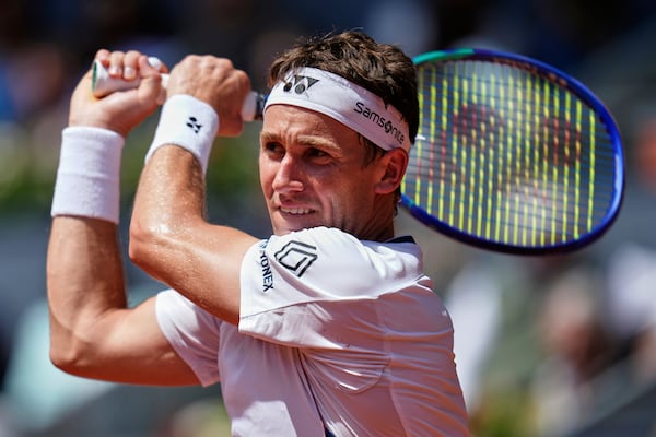 Casper Ruud of Norway returns the ball against against Russia's Daniil Medvedev during the Madrid Open tennis tournament in Madrid, Spain, Thursday, May 1, 2025. (AP Photo/Manu Fernandez)