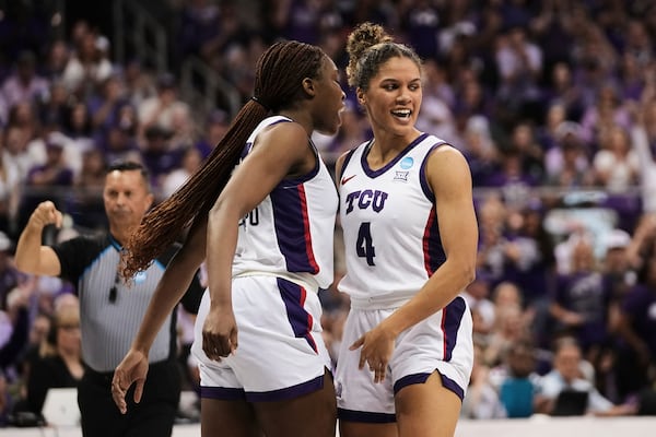 TCU's Agnes Emma-Nnopu, left, and Donovyn Hunter (4) celebrate in the second half against Louisville in the second round of the NCAA college basketball tournament in Fort Worth, Texas, Sunday, March 23, 2025. (AP Photo/Tony Gutierrez)