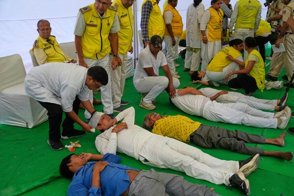 Civil defense members carry out a mock drill in a market to train civilians and security personnel to respond in case of attack, in New Delhi, India, Wednesday, May 7, 2025. (AP Photo/Manish Swarup)