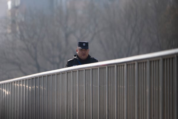 A Chinese security person patrols a bridge ahead of the National People's Congress in Beijing, on Feb. 28, 2025. (AP Photo/Ng Han Guan)