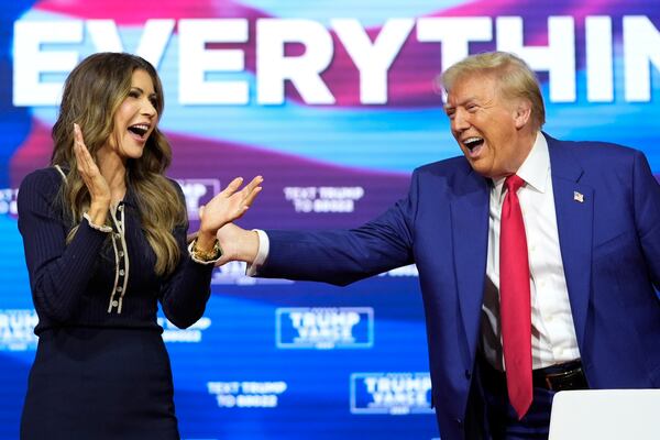 FILE - Republican presidential nominee former President Donald Trump reacts with South Dakota Gov. Kristi Noem after dancing to the song "Y.M.C.A." at a campaign town hall at the Greater Philadelphia Expo Center & Fairgrounds, Oct. 14, 2024, in Oaks, Pa. (AP Photo/Alex Brandon, File)