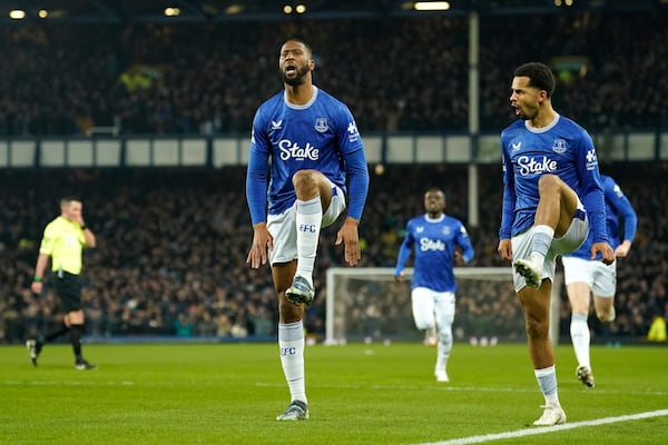 Everton's Beto, centre, celebrates with teammates after scoring his side's opening goal during the English Premier League soccer match between Everton and Liverpool, Liverpool, England, Wednesday, Feb.12, 2025. (AP Photo/Dave Thompson)