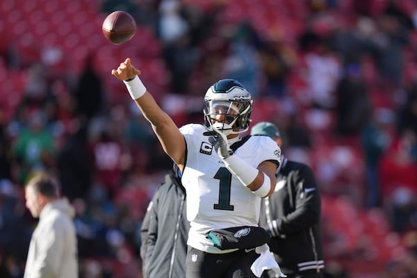 Philadelphia Eagles quarterback Jalen Hurts (1) throwing the ball before the start of an NFL football game against the Washington Commanders, Sunday, Dec. 22, 2024, in Landover, Md. (AP Photo/Stephanie Scarbrough)