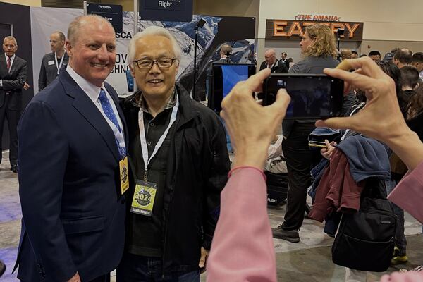 FILE - Berkshire Hathaway Vice Chairman Greg Abel poses for pictures with shareholders while touring the booths Berkshires companies set up, Friday, May 3, 2024, in Omaha, Neb. (AP Photo/Josh Funk, File)