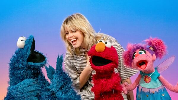 This image released by Sesame Workshop shows actor-singer Renee Rapp with muppet characters Cookie Monster, from left, Elmo and Abby Cadabby on the set of "Sesame Street." (Richard Termine/Sesame Workshop via AP)