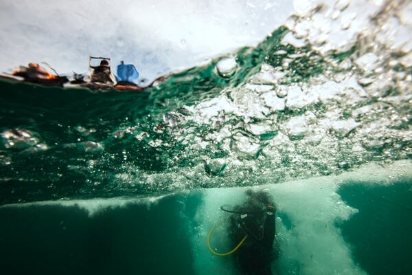 A diver enters the water to collect trash off the coast of Hon Mot Island on Feb. 7, 2025, in Nha Trang, Vietnam. (AP Photo/Yannick Peterhans)