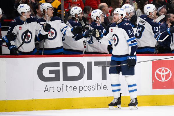 Winnipeg Jets defenseman Dylan Samberg (54) celebrates his goal during the first period of an NHL hockey game against the Washington Capitals, Saturday, Feb. 1, 2025, in Washington. (AP Photo/Nick Wass)