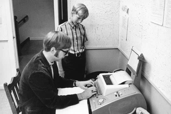 This image provided by Lakeside High School shows Bill Gates with his future Microsoft co-founder Paul Allen at a teletype machine in 1969 at Lakeside High School in Seattle. ( Lakeside High School via AP)