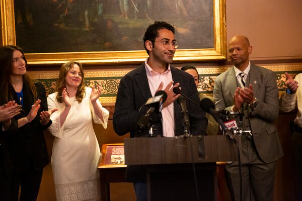 Mohsen Mahdawi, center, speaks during a press conference announcing the launch of the Vermont Immigration Legal Defense Fund in the Cedar Creek Reception Room at the Vermont State House on Thursday, May 8, 2025, in Montpelier, Vt. (AP Photo/Alex Driehaus)