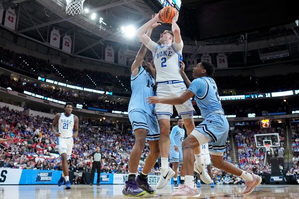 Duke forward Cooper Flagg drives to the basket between Mount St. Mary's forward Jedy Cordilia, left, and guard Arlandus Keyes during the first half in the first round of the NCAA college basketball tournament, Friday, March 21, 2025, in Raleigh, N.C. (AP Photo/Chris Carlson)