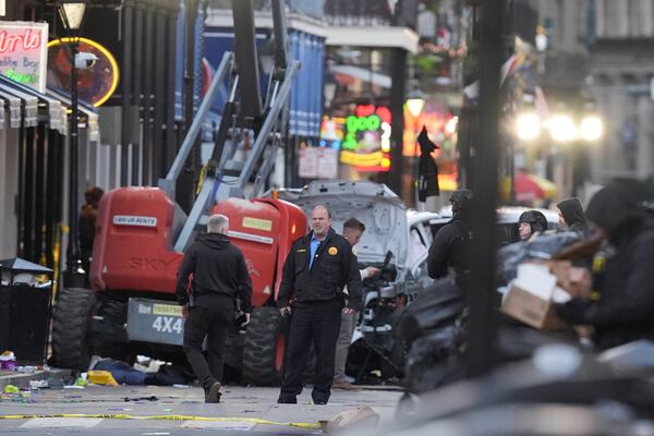 Emergency services attend the scene on Bourbon Street after a vehicle drove into a crowd on New Orleans' Canal and Bourbon Street, Wednesday Jan. 1, 2025. (AP Photo/Gerald Herbert)