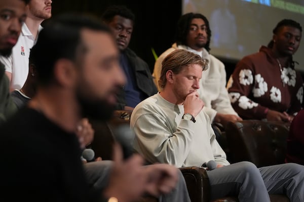 Athlete Grant House listens as others speak during a players association for college athletes meeting ahead of the college football's national title game, Saturday, Jan. 18, 2025, in Atlanta. (AP Photo/Brynn Anderson)