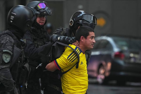 Police detain a soccer fan who joined retirees protesting for higher pensions and against austerity measures implemented by Javier Milei's government in Buenos Aires, Argentina, Wednesday, March 12, 2025. (AP Photo/Natacha Pisarenko)