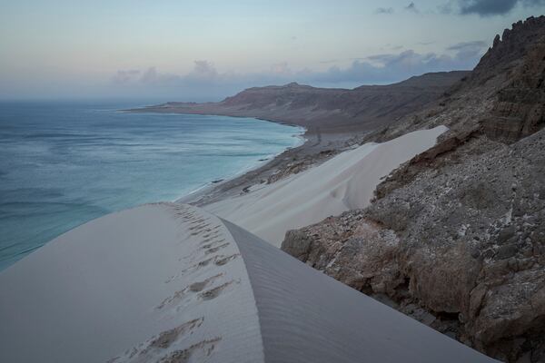Sand dunes plunge into the sea on the Yemeni island of Socotra on Sept. 21, 2024. (AP Photo/Annika Hammerschlag)