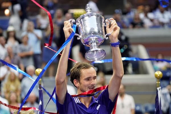 FILE - Daniil Medvedev, of Russia, holds up the championship trophy after defeating Novak Djokovic, of Serbia, in the men's singles final of the US Open tennis championships, Sept. 12, 2021, in New York. (AP Photo/John Minchillo, File)