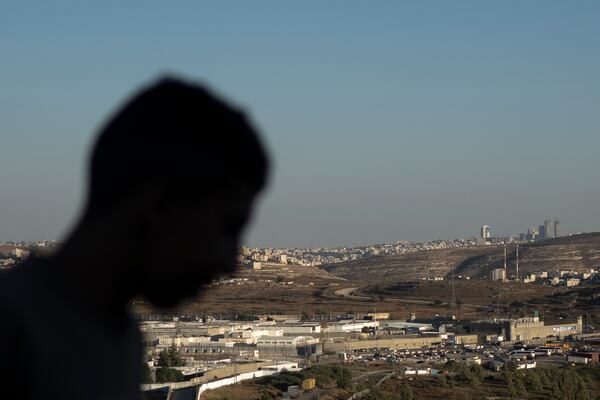 FILE - A Palestinian youth stands on a hill overlooking Israel's Ofer Prison, near the West Bank city of Ramallah, July 3, 2024. (AP Photo/Maya Alleruzzo, File)