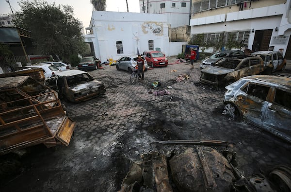 FILE - Men look over the site of a deadly explosion at Al-Ahli Hospital in Gaza City, on Oct. 18, 2023. (AP Photo/Abed Khaled, File)