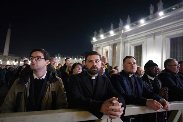 People attend as Cardinal Robert Francis Prevost, Prefect of the Dicastery for Bishops, leads the recitation of the Holy Rosary for Pope Francis' health in St Peter's Square at the Vatican, Monday, March 3, 2025. (AP Photo/Kirsty Wigglesworth)