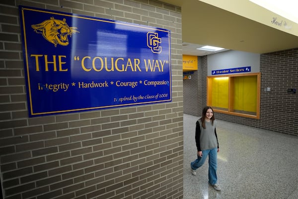 Makenzie Gilkison walks down the hallway at Greenfield Central High School, Tuesday, Dec. 17, 2024, in Greenfield, Ind. (AP Photo/Darron Cummings)