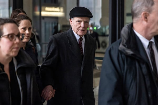 Flanked by supporters and holding hands with his daughter Nicole, Illinois' former House Speaker Michael Madigan walks out of the Dirksen Federal Courthouse in Chicago, Wednesday, Feb. 12, 2025. (Ashlee Rezin/Chicago Sun-Times via AP)