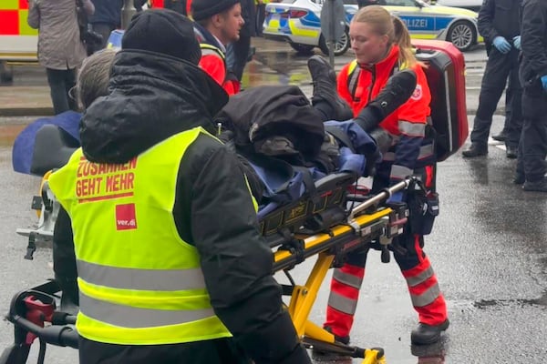 An injured person is taken away by emergency services at the scene of an accident after a driver hit a group of people in Munich, Germany, Thursday Feb. 13, 2025. (Michael Fischer/dpa via AP)