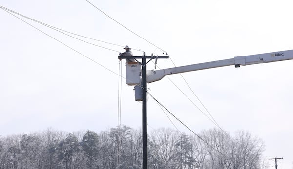 Utility crews work on power lines after a winter storm blanketed the area Thursday, Feb. 13, 2025, Franklin County, Va. (Heather Rousseau