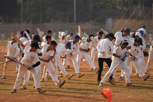 Indian children practice batting at a cricket coaching camp in Mumbai, India, Friday, Feb. 21, 2025. (AP Photo/Rajanish Kakade)