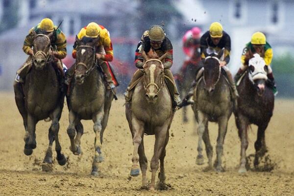 FILE- Red Bullet (4), with jockey Jerry Bailey aboard, center, breaks away from the field in the stretch to win 125th running of the Preakness Stakes at Pimlico Race Course in Baltimore, Saturday, May 20, 2000. (AP Photo/Roberto Borea, File)