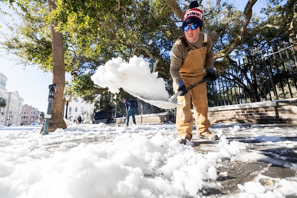 Dylan Gilbert, with the City of Charleston, removes snow in front of City Hall after a winter storm dropped ice and snow Wednesday, Jan. 22, 2025, on Charleston, S.C. (AP Photo/Mic Smith)