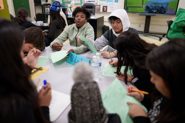 A tutor helps students at Benjamin O. Davis Middle School in Compton, Calif., Thursday, Feb. 6, 2025. (AP Photo/Eric Thayer)