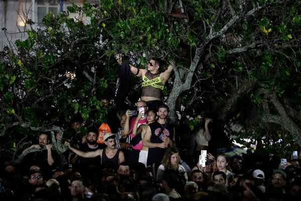 Fans watch Lady Gaga rehearse a day ahead of her free concert, on Copacabana beach, in Rio de Janeiro, Friday, May 2, 2025. (AP Photo/Bruna Prado)