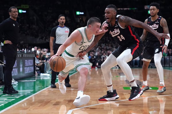 Boston Celtics guard Payton Pritchard, left, drives to the basket against Portland Trail Blazers forward Jabari Walker (34) during the second half of an NBA basketball game, Wednesday, March 5, 2025, in Boston. (AP Photo/Charles Krupa)