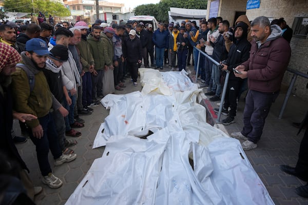 Palestinians attend funeral prayers over the bodies of those killed in overnight Israeli airstrikes on the Maghazi refugee camp, at Al-Aqsa Hospital, in Deir al-Balah, central Gaza Strip, Saturday, Dec. 28, 2024. (AP Photo/Abdel Kareem Hana)