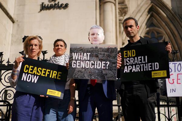 Demonstrators gather outside the Royal Courts of Justice in London, where Palestinian human rights organization Al-Haq is taking legal action against the Department for Business and Trade over several decisions, Tuesday. May 13, 2025. (Ben Whitley/PA via AP)